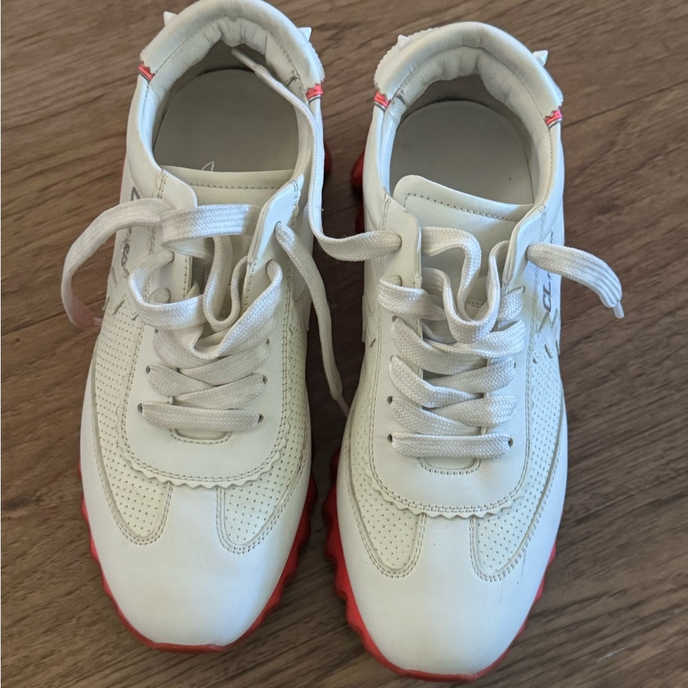 The rare, hot pink and red shark Christian Louboutin tennis shoe.
